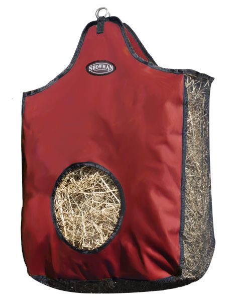 Hay bag hanging from a fence, demonstrating its practical use outdoors.